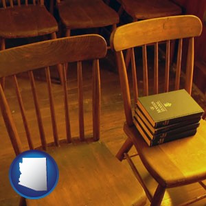 wooden chairs and hymnals in an old church building - with Arizona icon