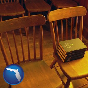 wooden chairs and hymnals in an old church building - with Florida icon
