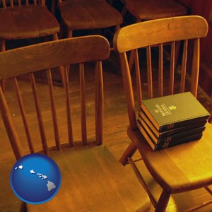 wooden chairs and hymnals in an old church building - with Hawaii icon