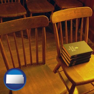 wooden chairs and hymnals in an old church building - with Kansas icon