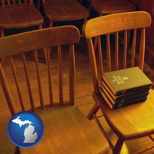 wooden chairs and hymnals in an old church building - with Michigan icon