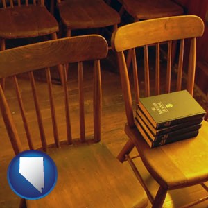 wooden chairs and hymnals in an old church building - with Nevada icon