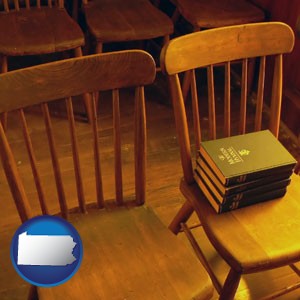 wooden chairs and hymnals in an old church building - with Pennsylvania icon