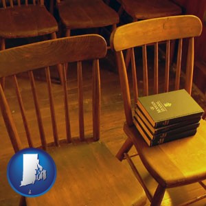 wooden chairs and hymnals in an old church building - with Rhode Island icon