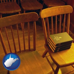 wooden chairs and hymnals in an old church building - with West Virginia icon