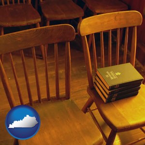 wooden chairs and hymnals in an old church building - with Kentucky icon